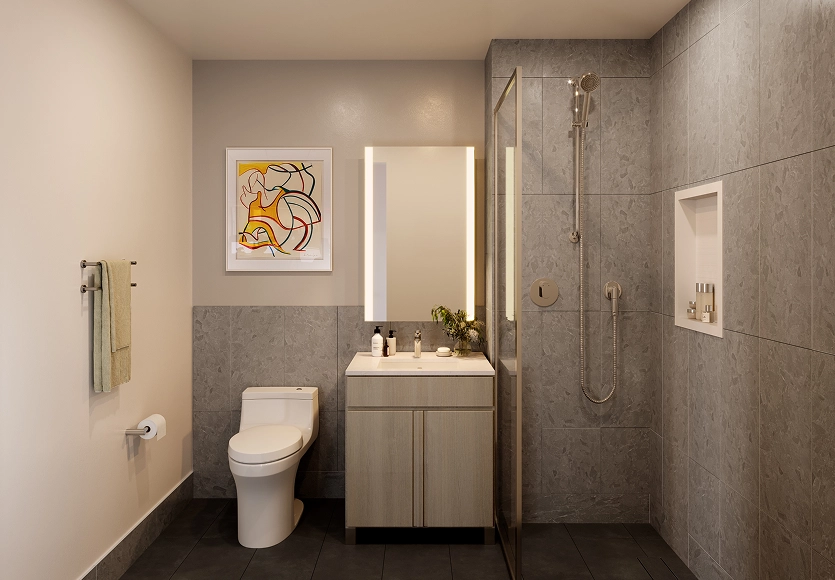 Elegant bathroom interior with marble-style walls and frameless glass shower at 89 DeKalb apartments in Fort Greene.